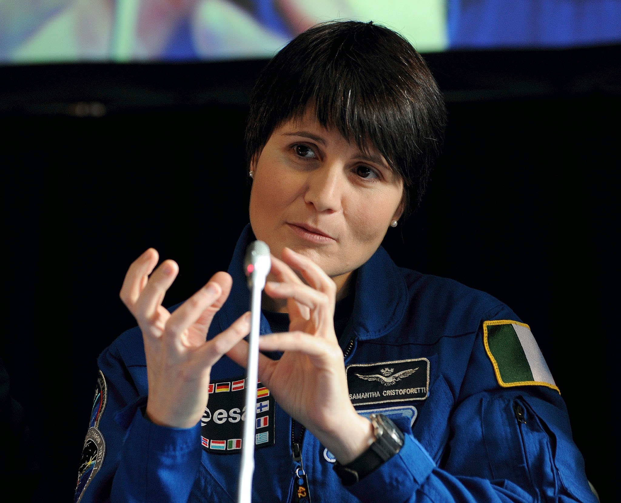 photo of Italian astronaut Samantha Cristoforetti at a press conference in Milan, using her hands to get across a point.